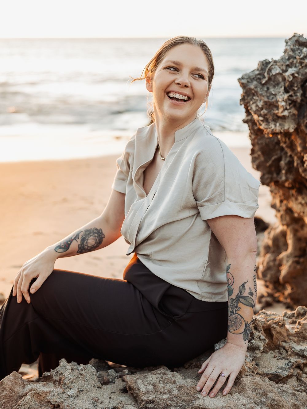 Tilly, the counsellor behind Grounded Counselling Co., on the beach at sunset